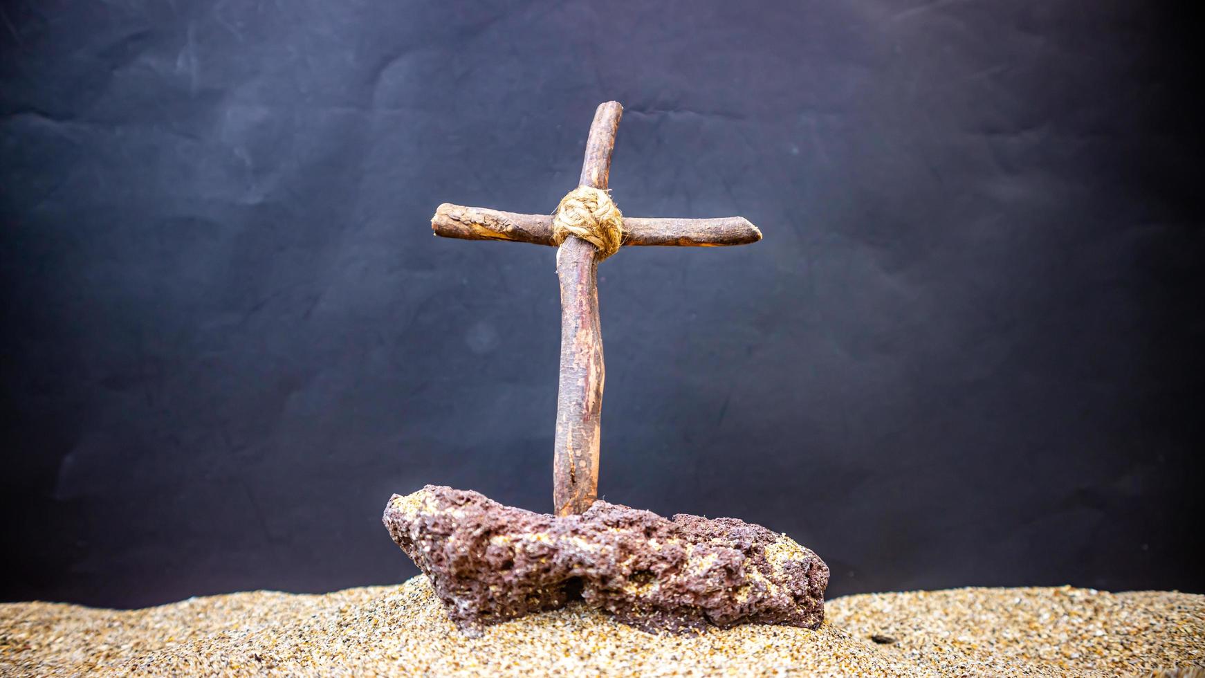 wooden cross on black background photo