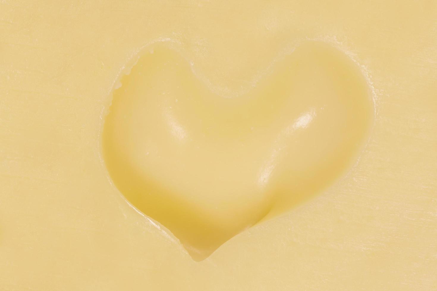 hole in shape of heart in maasdam cheese photo