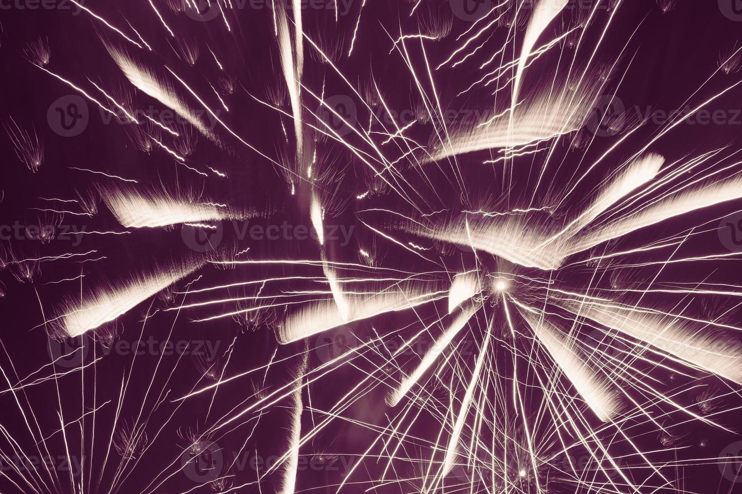 bright fireworks against violet background photo