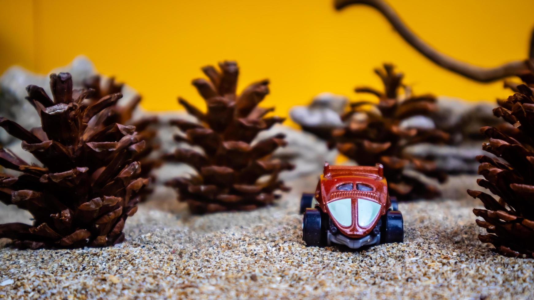 Minahasa, Indonesia  December 2022, the toy car among the pine cones photo