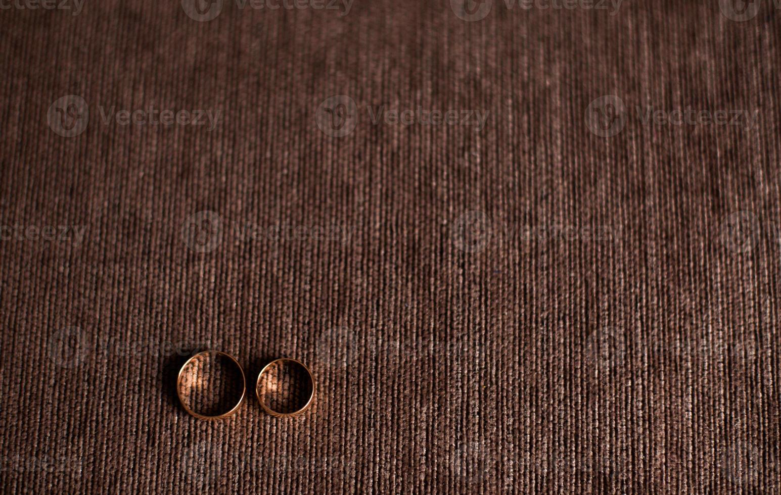 Wedding rings on a wooden background photo