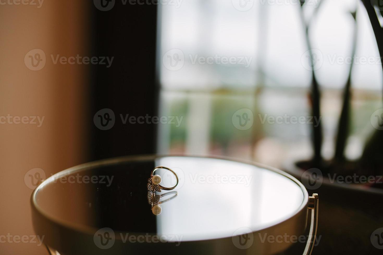 Delicate Wedding background with Rings and Buttercup Flower photo