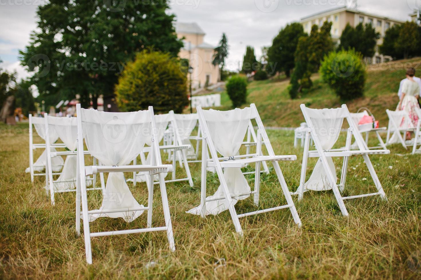 fragment like view of nice chairs ready for wedding ceremony photo