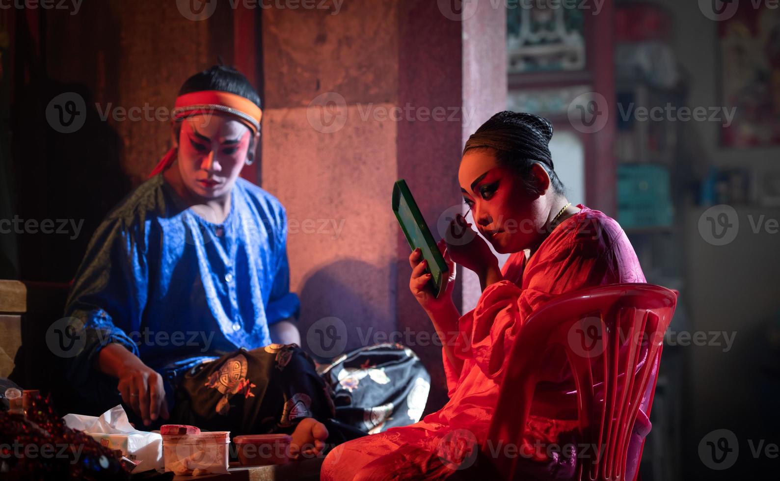 Male and female Chinese opera actors, Sit and make up to be the typical color of the show as the protagonist. photo