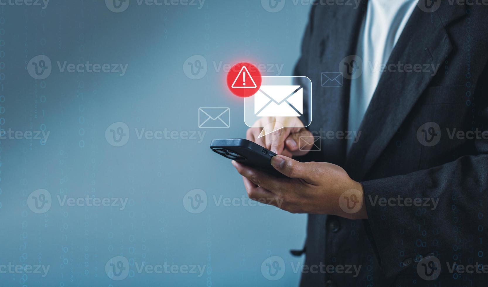 Businessman using smartphone with electronic email hacking and spam warning symbol. cyber attack network, virus, spyware, Cyber security and cybercrime photo