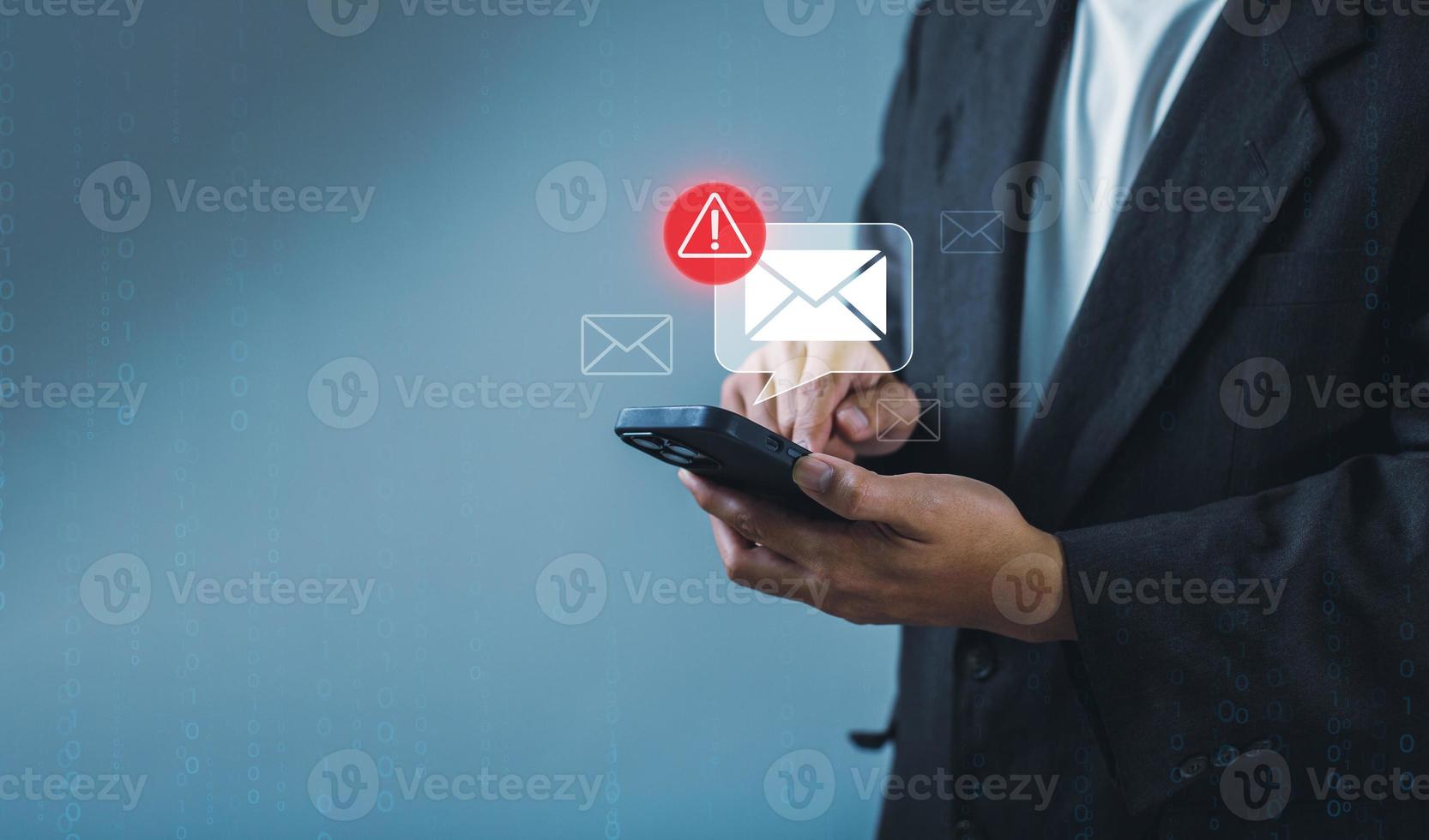 Businessman using smartphone with electronic email hacking and spam warning symbol. cyber attack network, virus, spyware, Cyber security and cybercrime photo