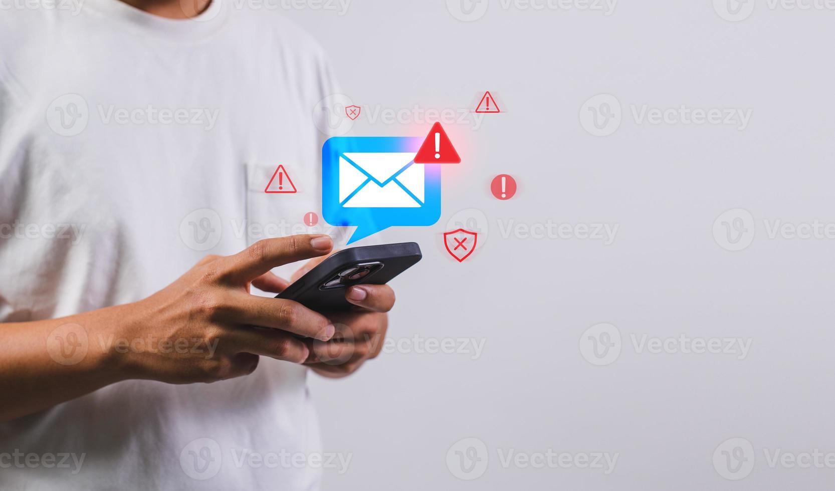 Businessman using smartphone with electronic email hacking and spam warning symbol. cyber attack network, virus, spyware, Cyber security and cybercrime photo