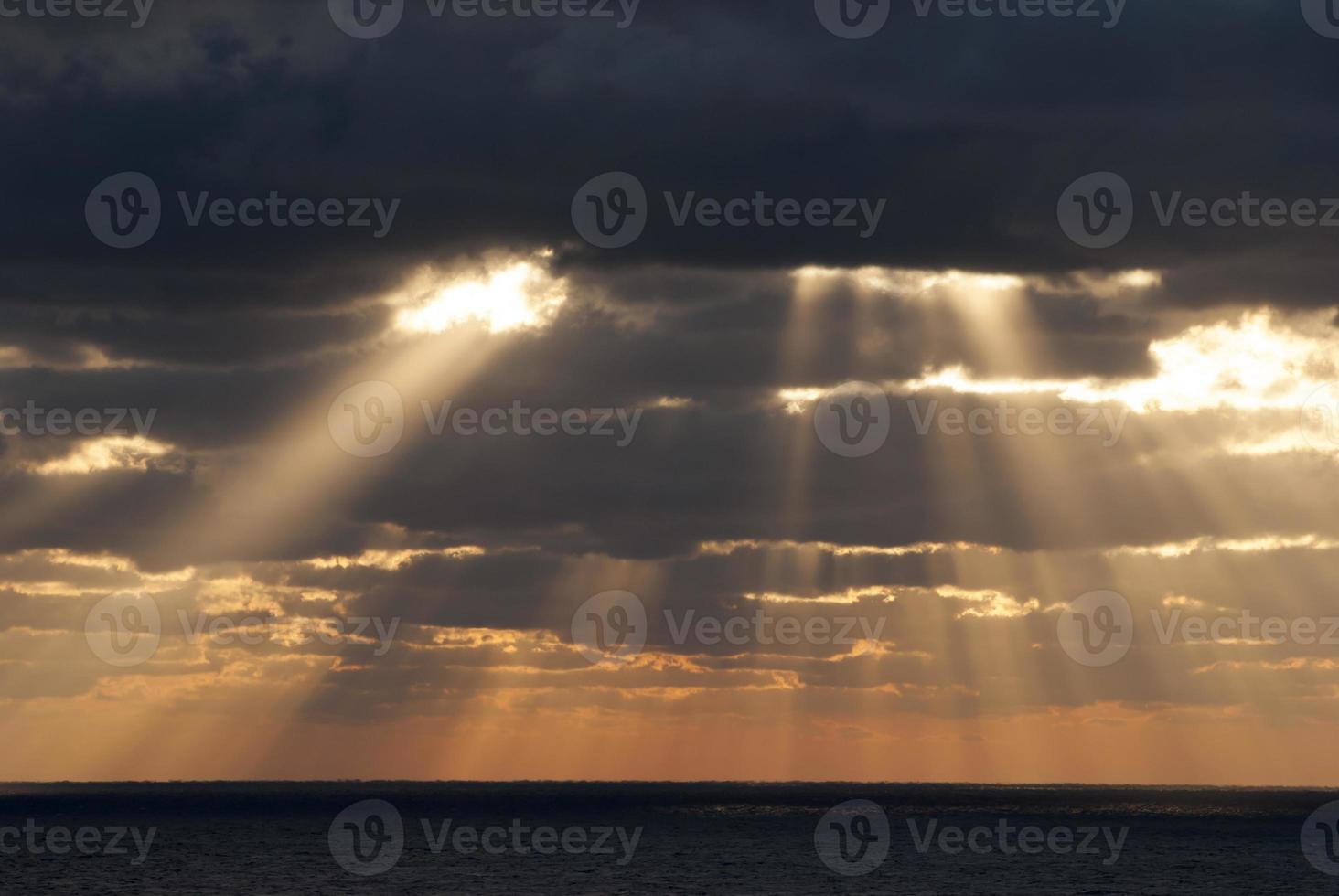 Caribbean Evening Sunlight Through Dark Clouds photo