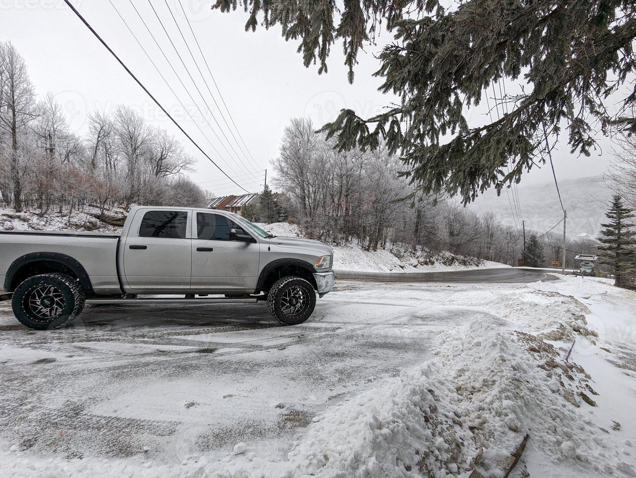 Pickup truck on road, Beautiful winter road under snow mountains. photo