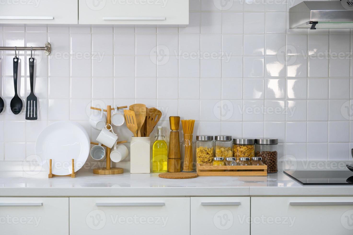 Kitchen utensils and kitchenware on white countertop at home photo