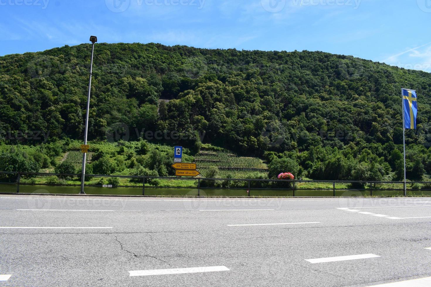 road intersection with a view to green steep vineyards photo