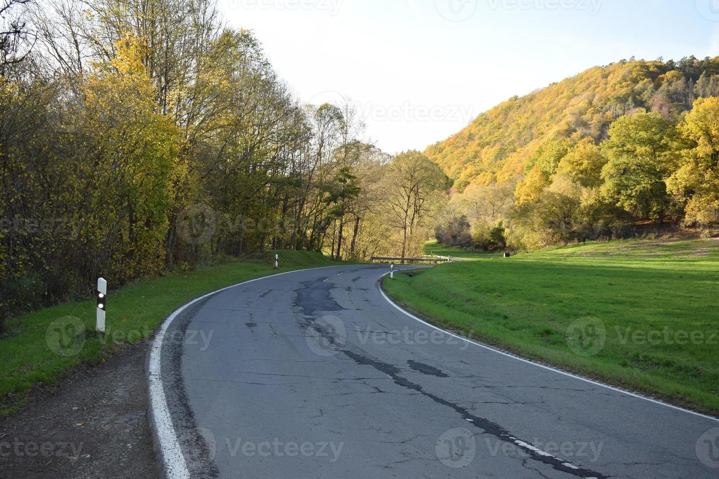 badly repaired road in autumn photo