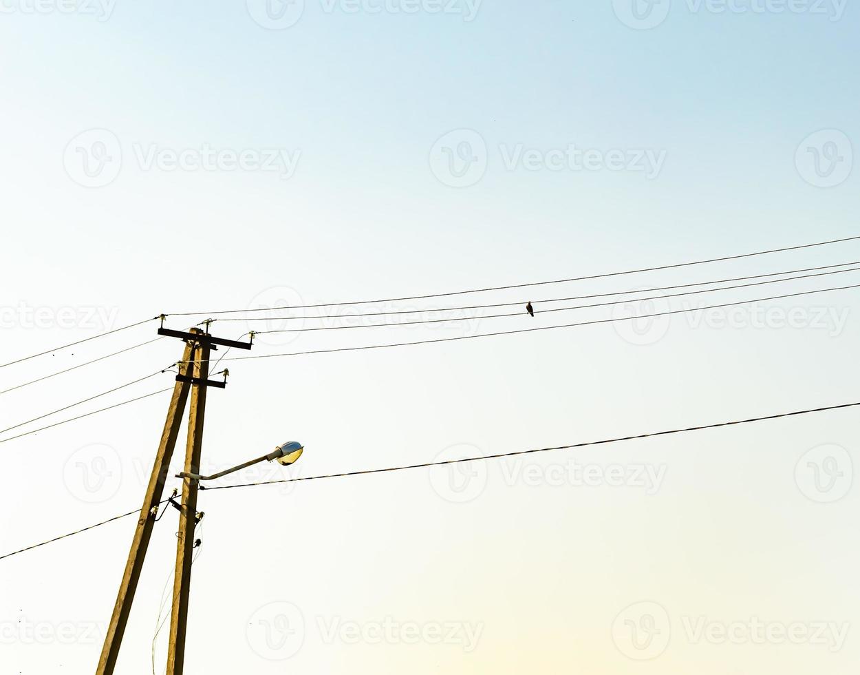 Power electric pole with line wire on colored background close up photo