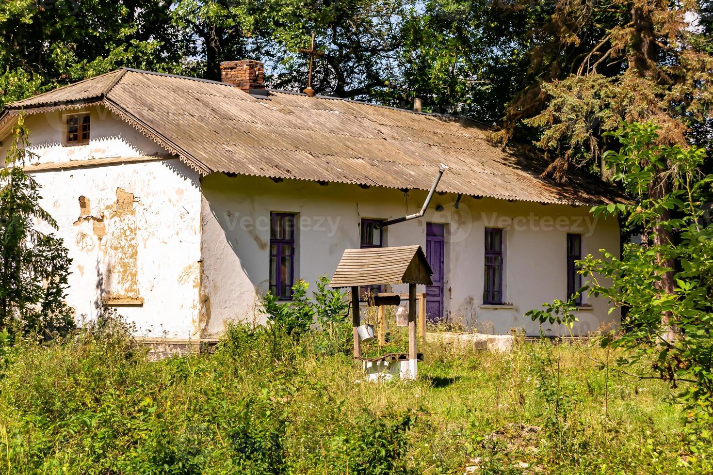 Beautiful old abandoned building farm house in countryside on natural background photo