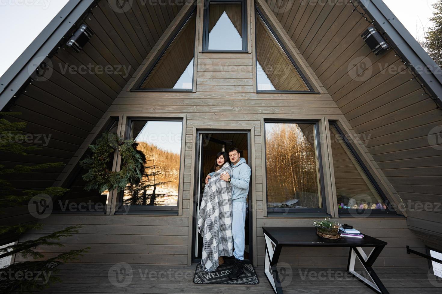 Couple in love on terrace off grid tiny house in the mountains. photo