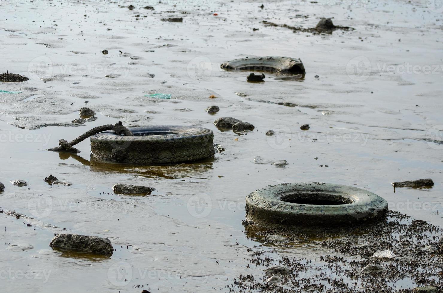 Old tire thrown at coastal photo