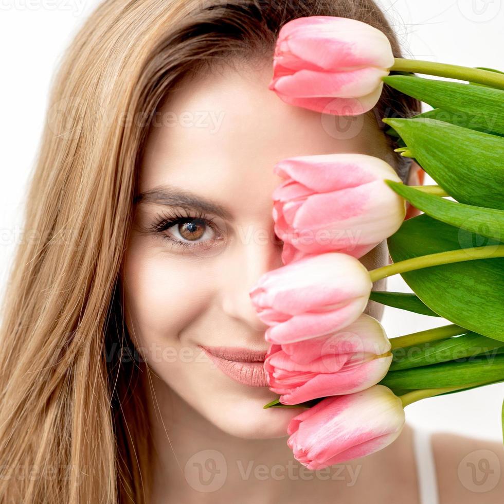 Portrait of woman with pink tulips photo