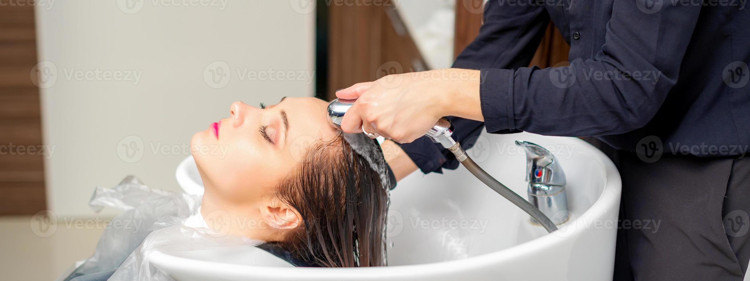 Hairdresser is rinsing the hair photo