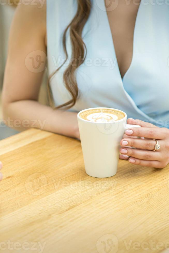 Female hands with cup of coffee photo