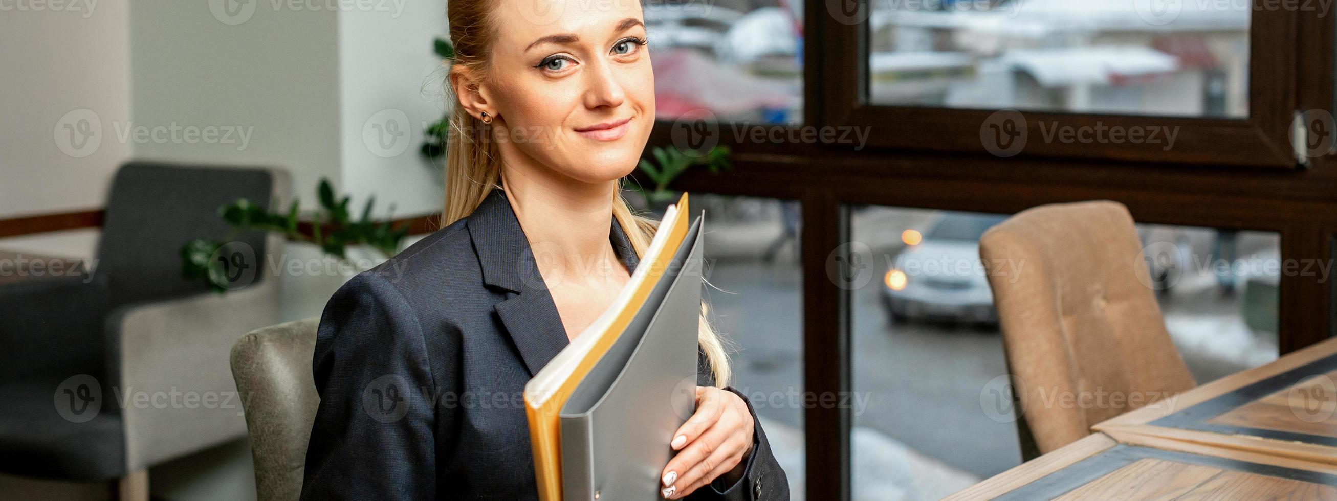 Businesswoman with folder with documents photo