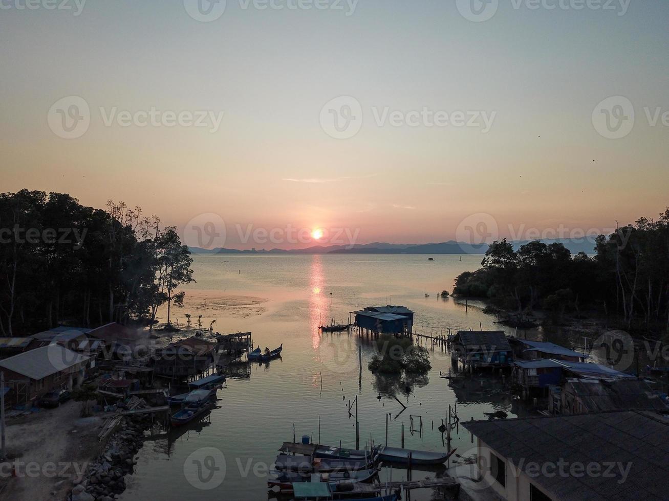 Fishing village in sunset photo