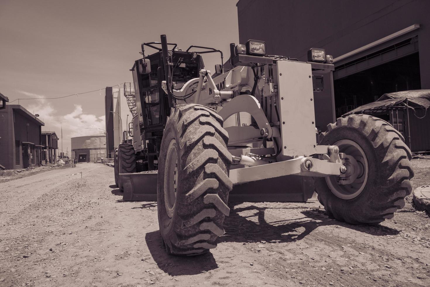 Land scraper and Vibro roller the heavy equipment for pretreatment road construction.  The photo is suitable to use for industry background photography, power plant poster and electricity.