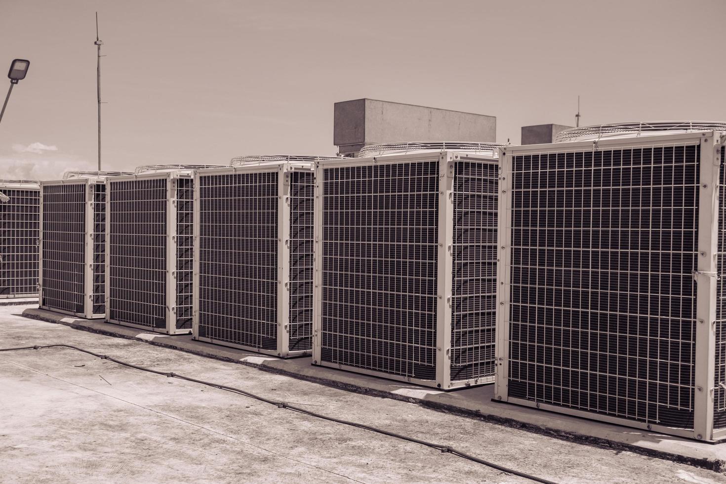 Array of outdoor fan air conditioner on the roof top building. The photo is suitable to use for construction and maintenance of air conditioner.