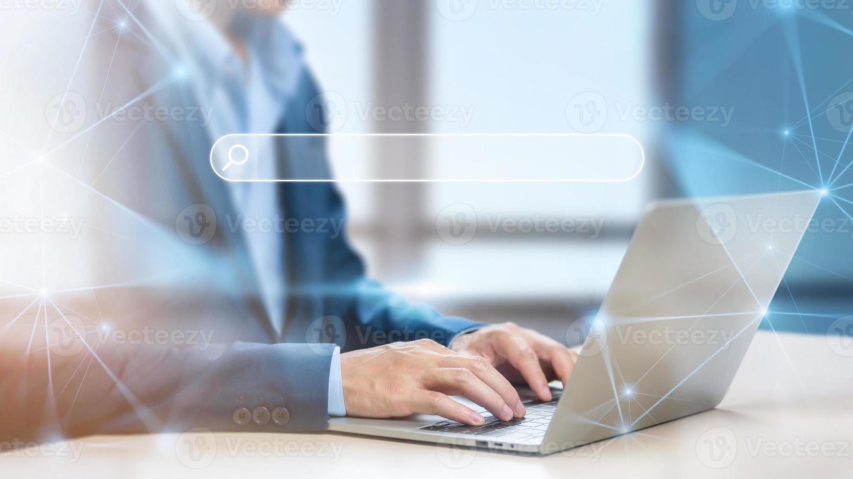 Businessman using computer searching information web browser webpage, Search Engine Optimization and Data Search Technology Concept, Internet network connecting online worldwide on office background photo