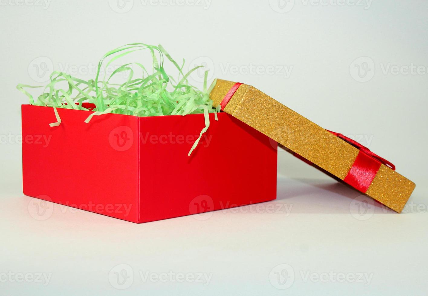 red box with green ribbon inside photo