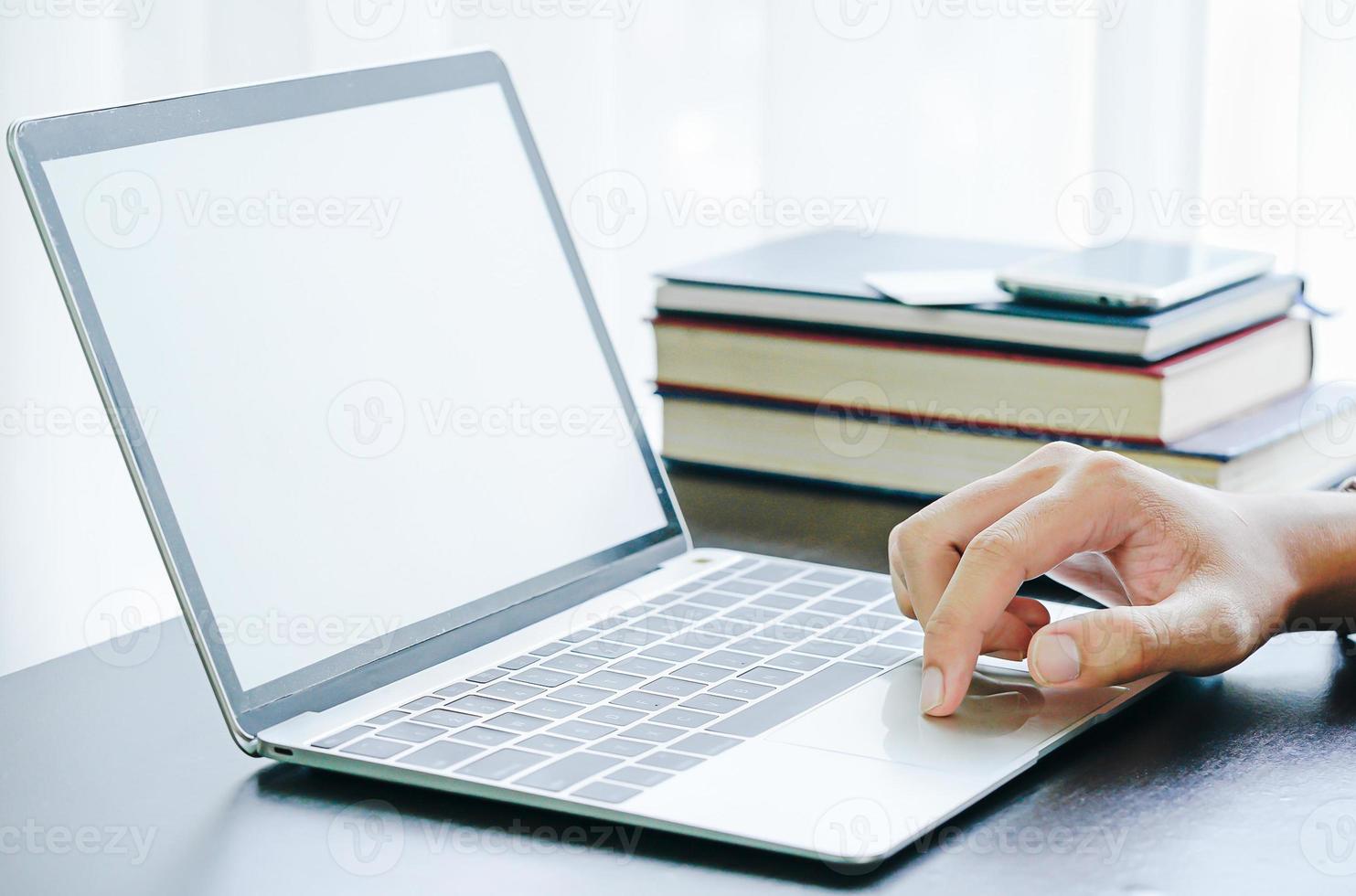 Male working with Laptop computer on the table photo