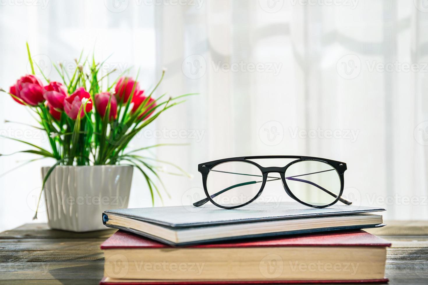 Eye glasses are placed on books photo
