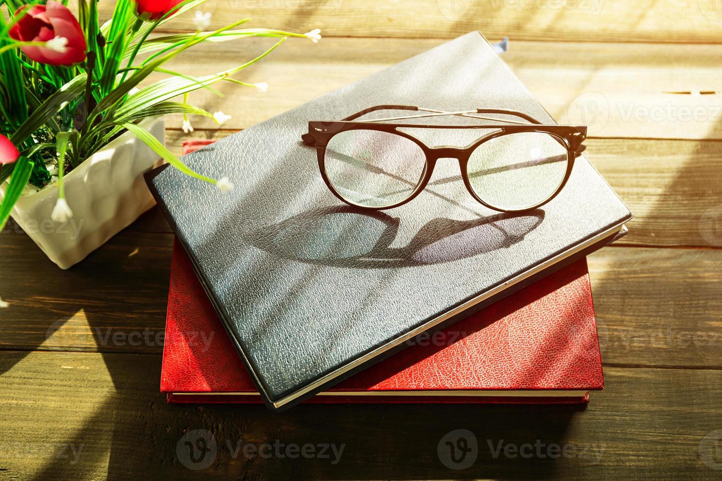 Eye glasses are placed on books photo