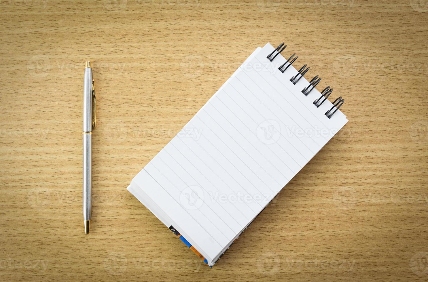 Pen and notepad with blank page photo