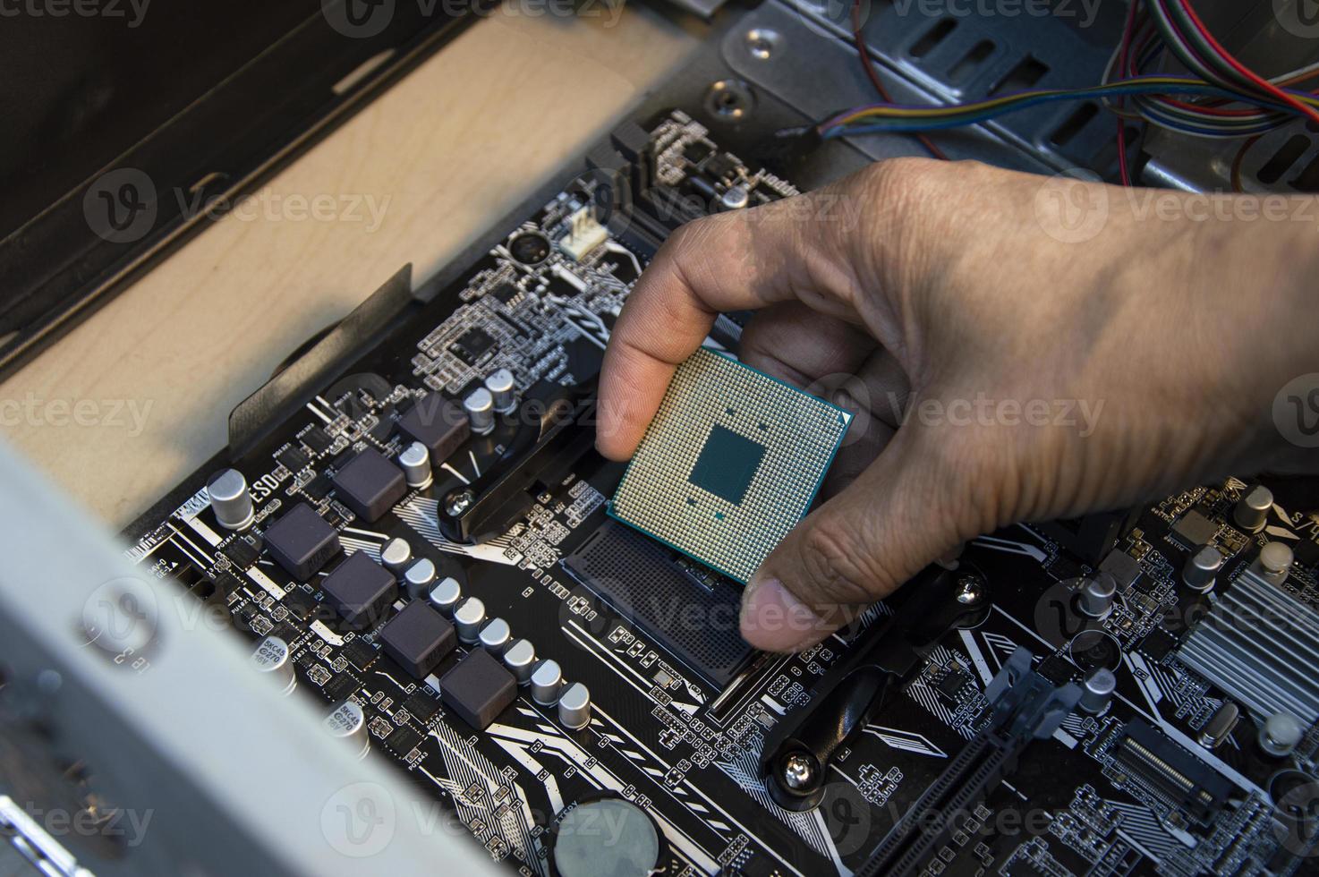 top view technician inserting cpu, computer assembler photo