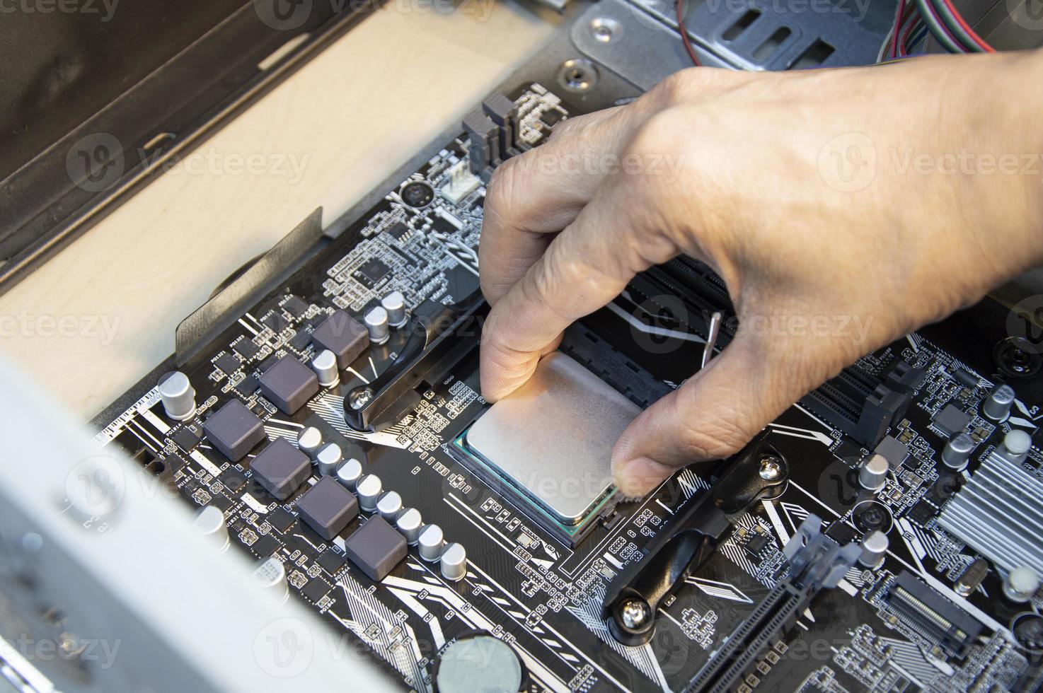 top view technician inserting cpu, computer assembler photo