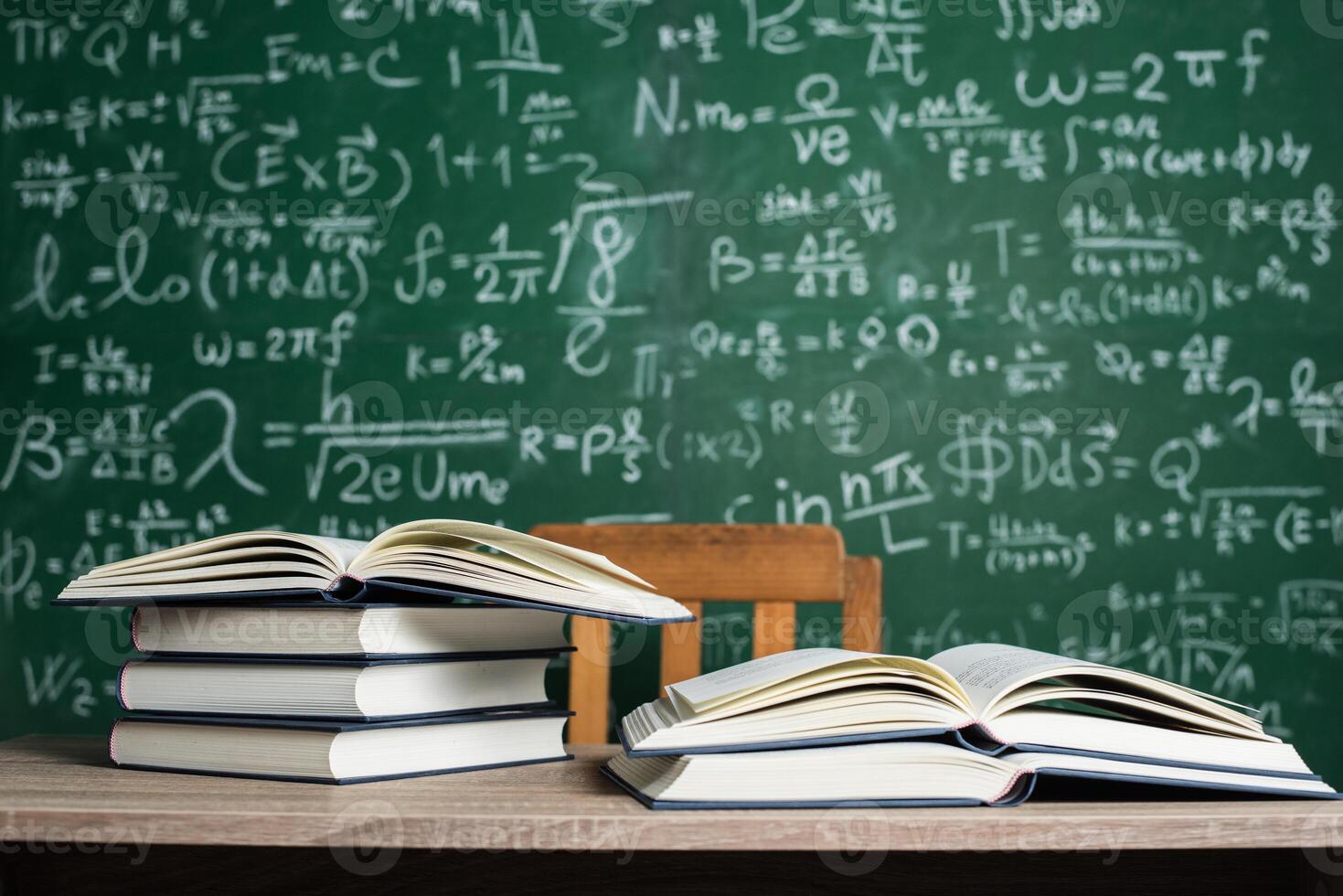 books and green board in classroom photo