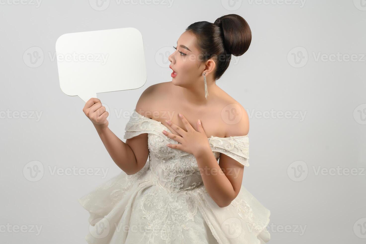 Young asian beautiful bride pose with mockup banner in hand photo