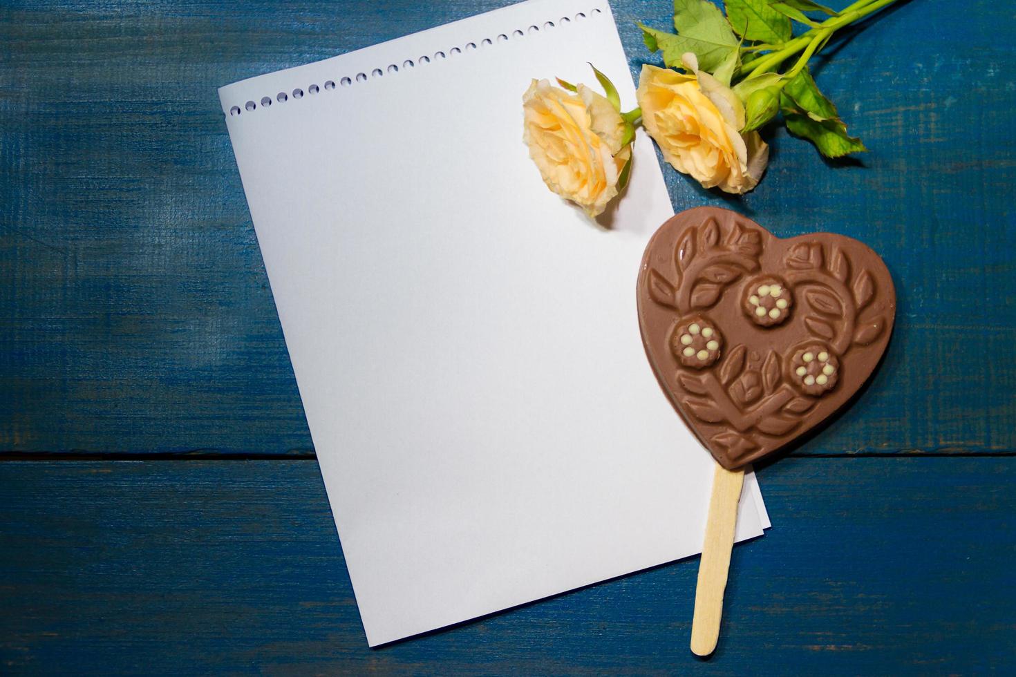 roses and chocolate heart on the crustica wood with place for text photo