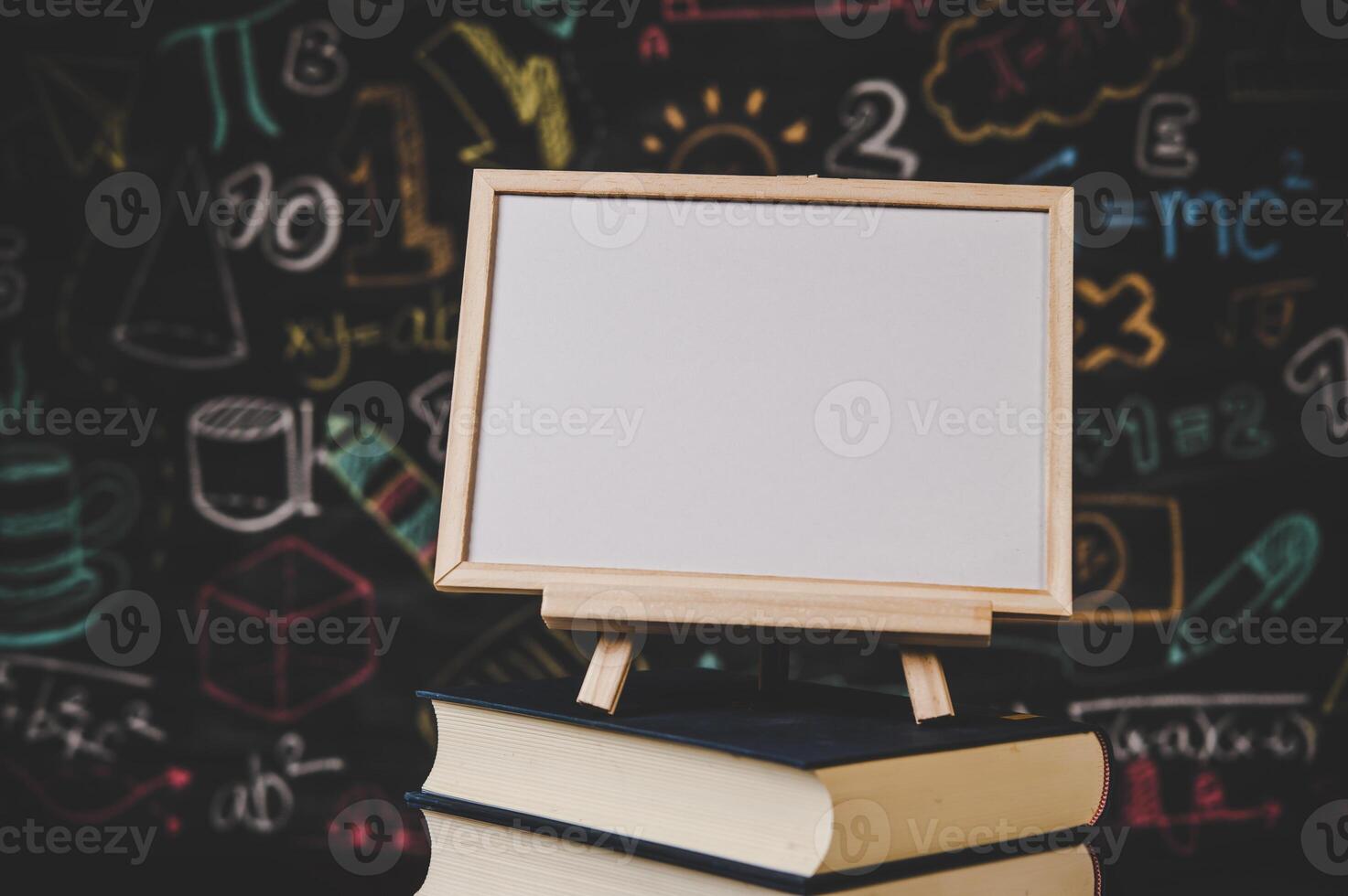 black photo frame on the stand on the books in classroom