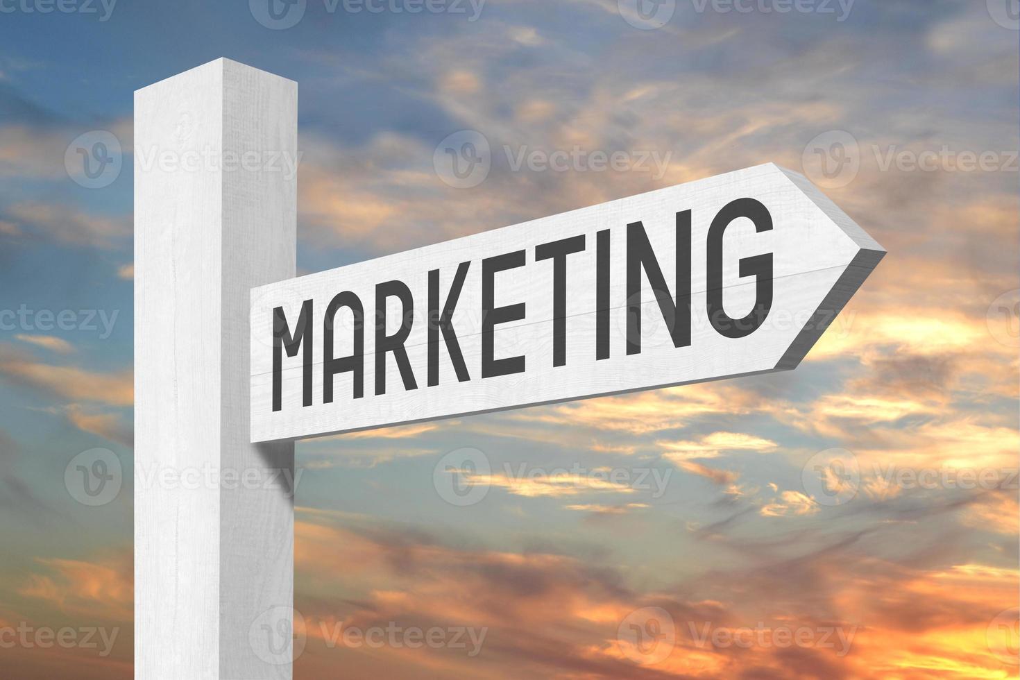 Marketing - White Wooden Signpost with one Arrow and Sunset Sky in Background photo