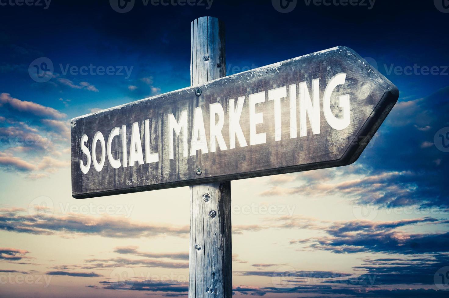 Social Marketing - Wooden Signpost with one Arrow, Sunset Sky in Background photo