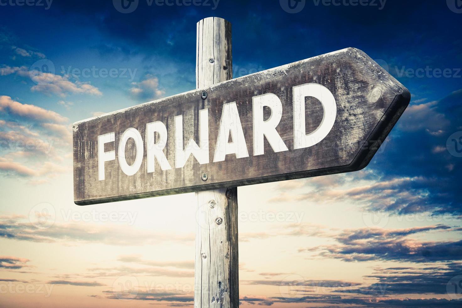 Forward - Wooden Signpost with one Arrow, Sunset Sky in Background photo