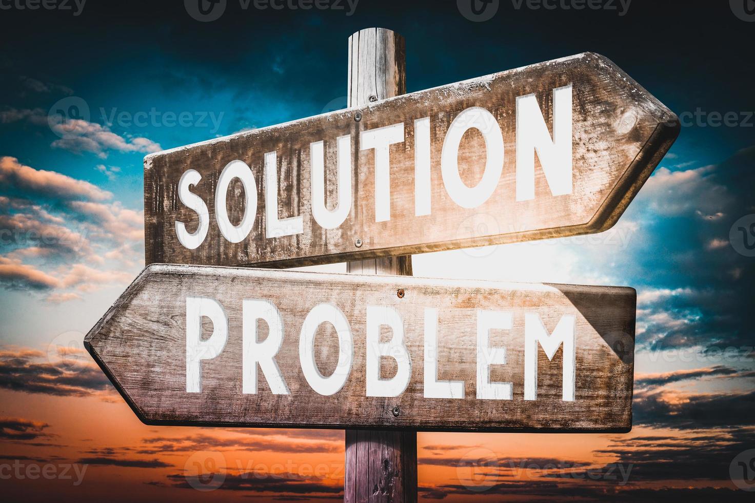 Problem, Solution - Wooden Signpost with Two Arrows, Sunset Sky in Background photo