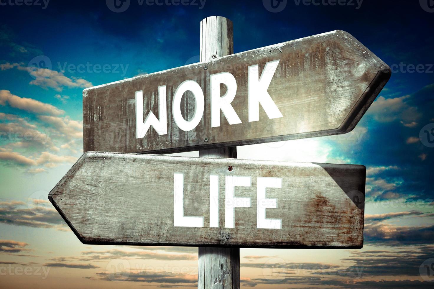 Work, Life - Wooden Signpost with Two Arrows, Sunset Sky in Background photo