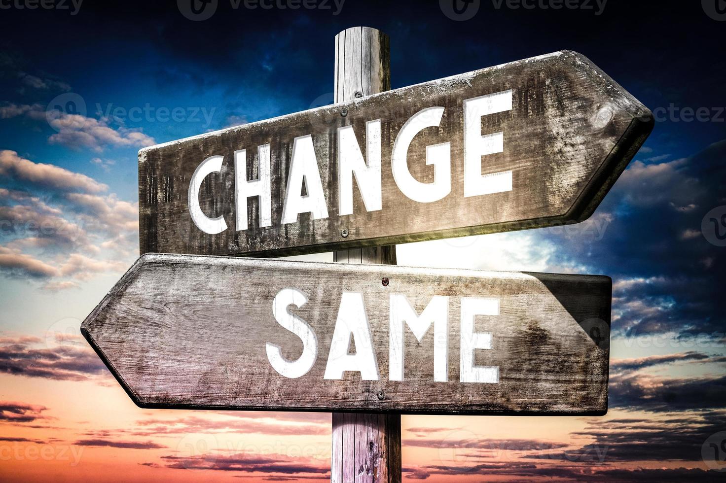 Change, Same - Wooden Signpost with Two Arrows, Sunset Sky in Background photo
