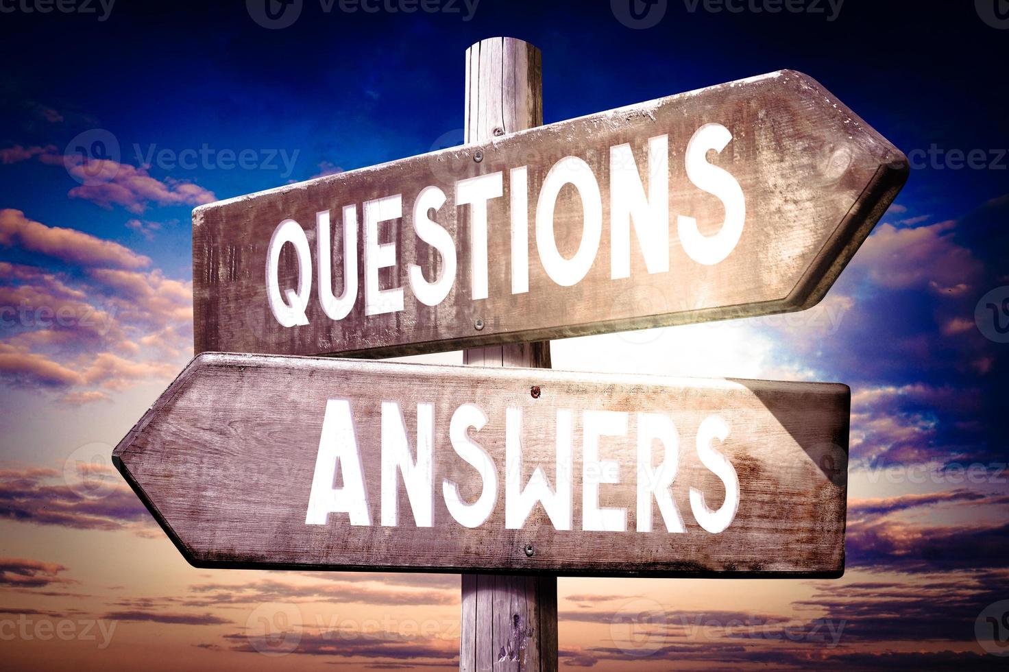 Questions, Answers - Wooden Signpost with Two Arrows, Sunset Sky in Background photo