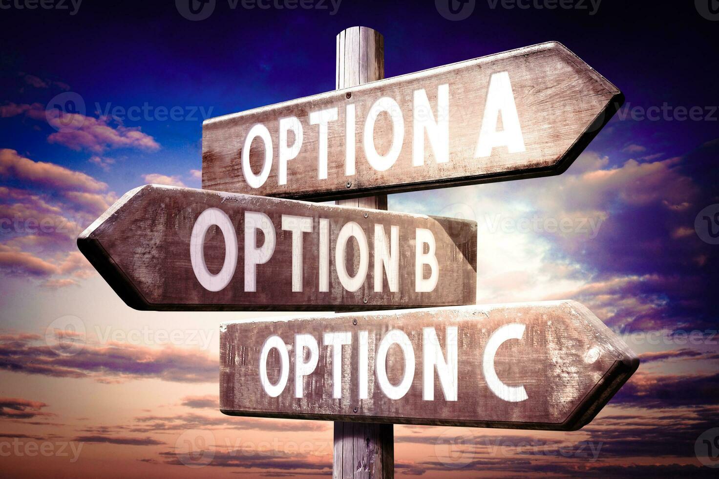 Option A, B, C - Wooden Signpost with Three Arrows, Sunset Sky in Background photo