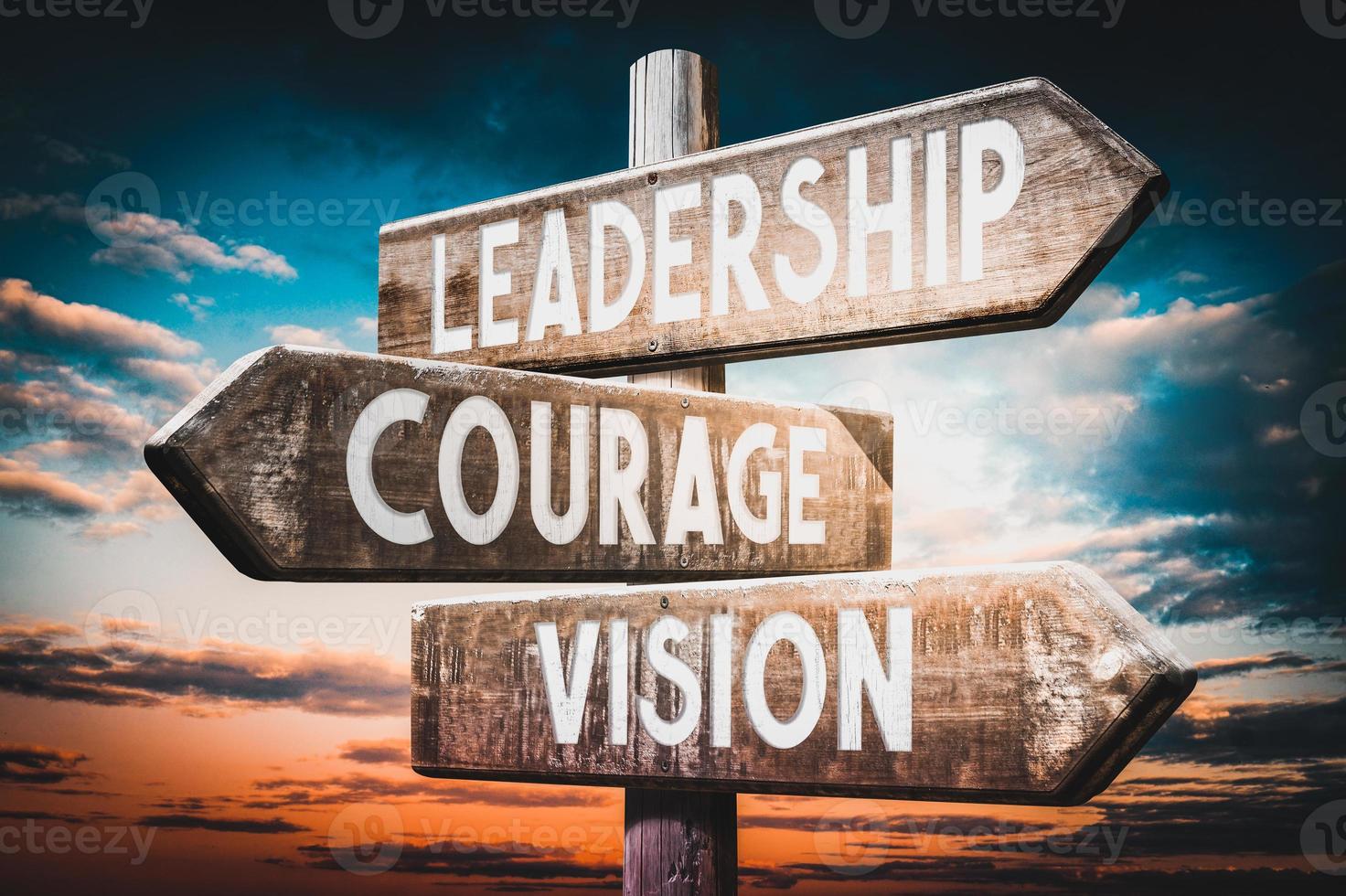 Leadership, Courage, Vision - Wooden Signpost with Three Arrows, Sunset Sky in Background photo