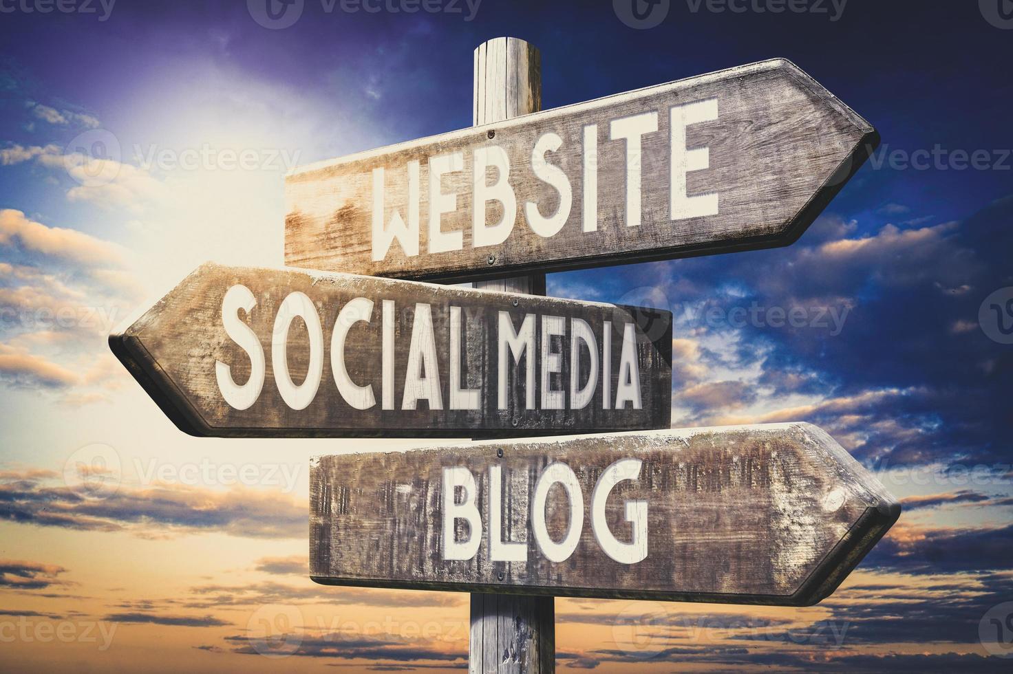 Website, Social Media, Blog - Wooden Signpost with Three Arrows, Sunset Sky in Background photo