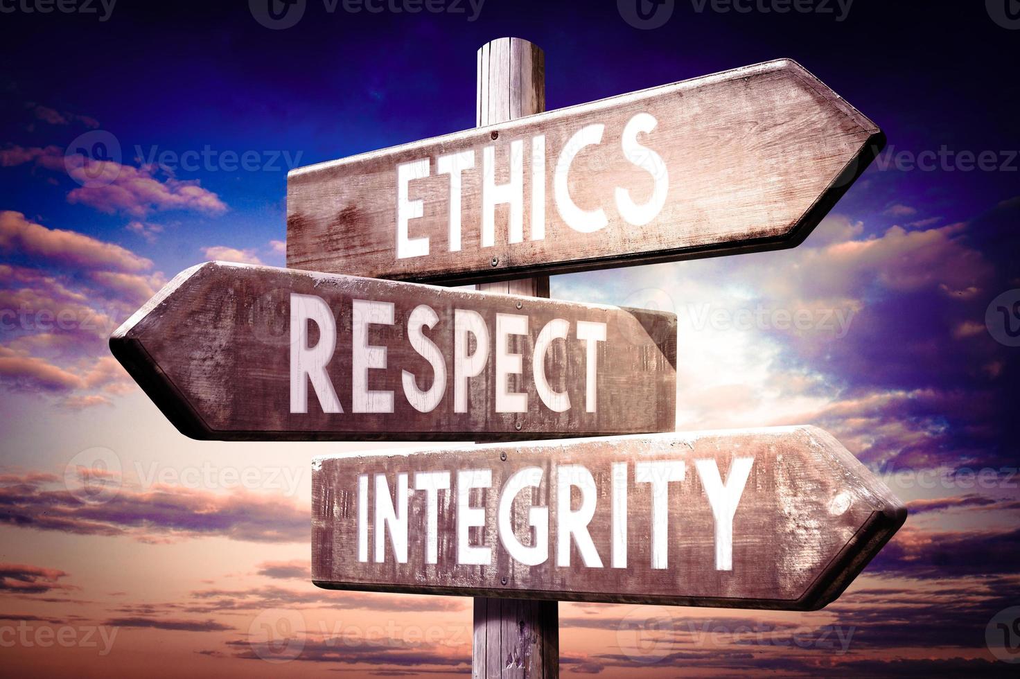 Ethics, Respect, integrity - Wooden Signpost with Three Arrows, Sunset Sky in Background photo